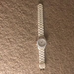 A white watch with rose gold